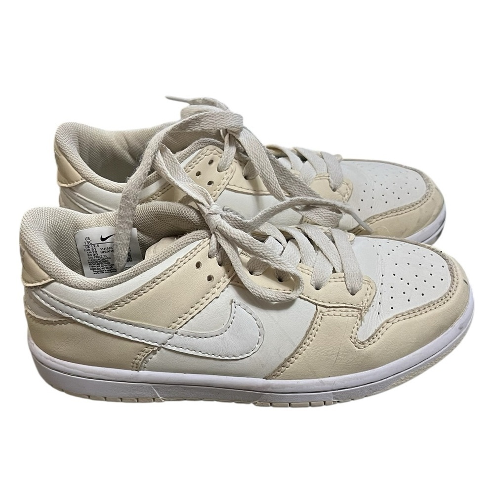 Nike low dunks lace up sneakers in cream and white
